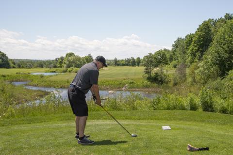 man lining up to take a golf swing