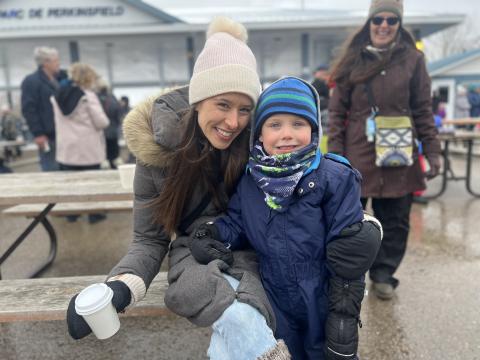 young mom and their child dressed in winter clothing enjoying the day at a previous winter carnaval d'hiver event