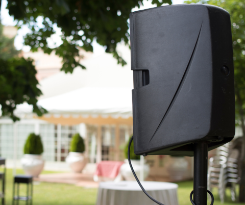 speaker at an event set up in someone's backyard