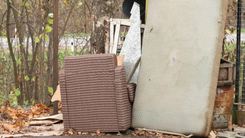 roadside debris such as broken chair, mattress, and scrap metal