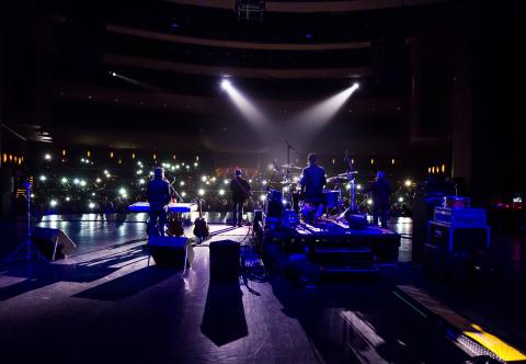 view from behind Hotel California (an Eagles cover band) looking out into the crowd during a concert