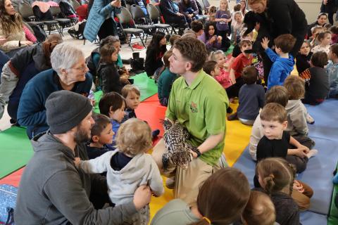 Zoo to You staff in the crowd showing a large lizard