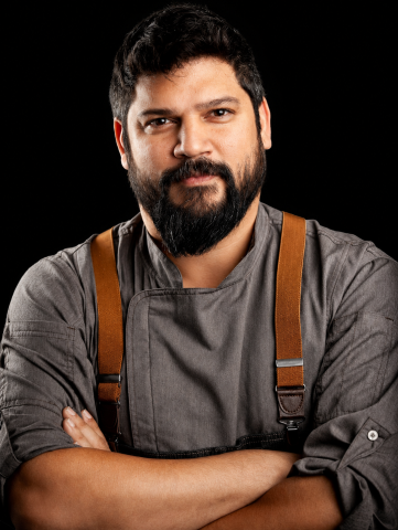 Chef Bradley Yip wearing a grey shirt and brown suspenders